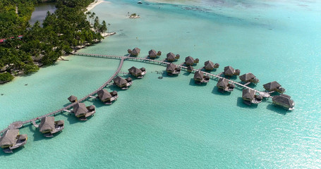 Water bungalows resort at islands, french polynesia in aerial view