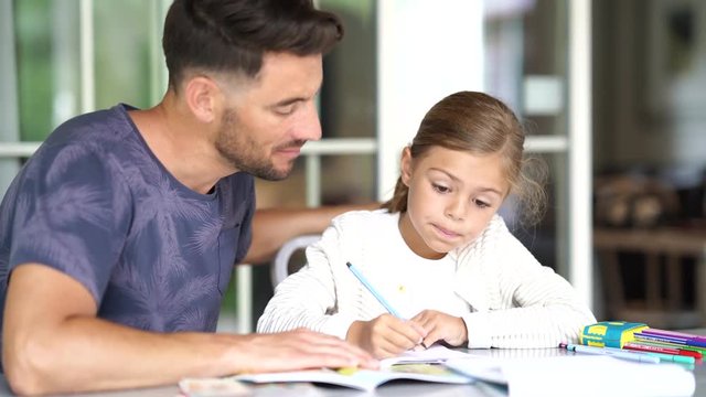 Daddy with little girl doing homework