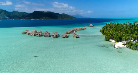 Water bungalows resort at islands, french polynesia in aerial view