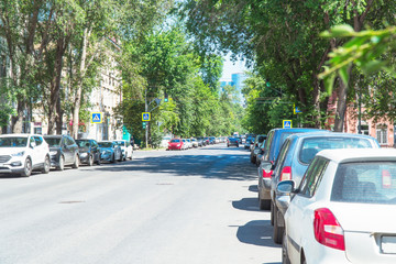Cars parked on the street on the outskirts of the city