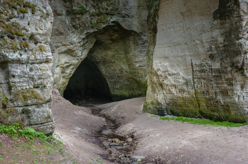 Natural cave in sandstone rock. Entrance to the cave called Little Hell in the Gauja National Park, Latvia.