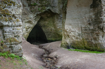 Natural cave in sandstone rock. Entrance to the cave called Little Hell in the Gauja National Park,...