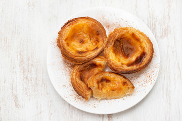 typical portuguese egg tart pastel de nata with cinnamon