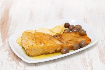 fried cod fish with olive oil on dish