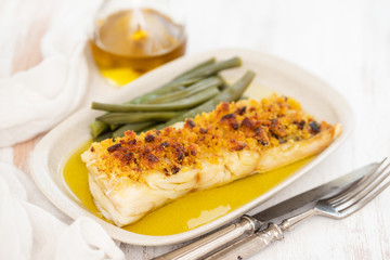 cod fish with corn bread and green beans on dish