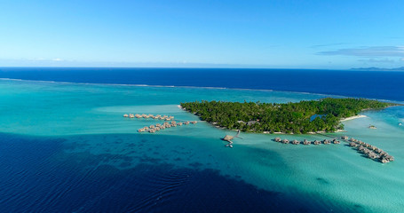 Water bungalows resort at islands, french polynesia in aerial view