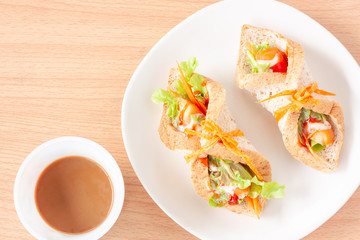 Sandwich whole wheat bread with sausage and coffee