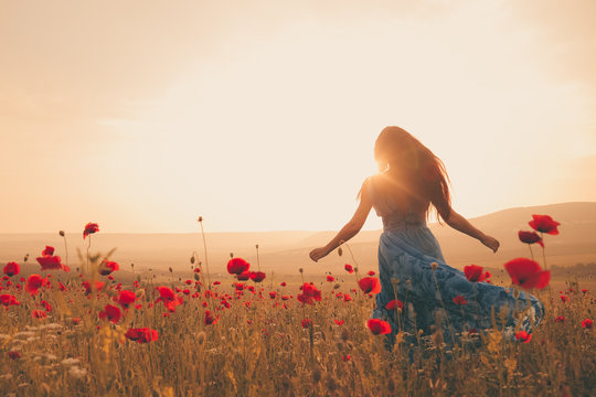 Young beautiful woman in spring field