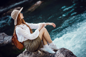 A beautiful young woman near river in the forest.
