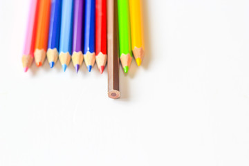 Stack of color pencil on white background.Difference idea concept.