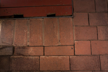 Obraz premium old brick floor with a fragment of a wooden hatch