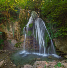 Obraz premium Mountain River with, forest landscape. Tranquil waterfall scenery in the middle of green forest