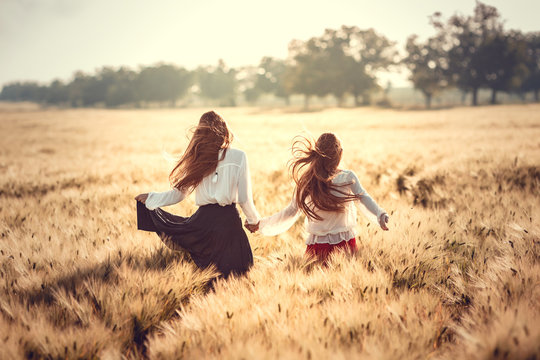 Two young women are looking forward tothe sunset. Best friends