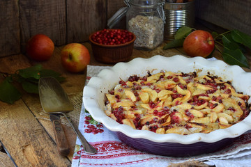 Homemade organic apple pie with cowberry on wooden background. Berry and fruits cake ready to eat. Homemade baking. Healthy pastries. Vegetarian food. Rustic photo. Copy space.