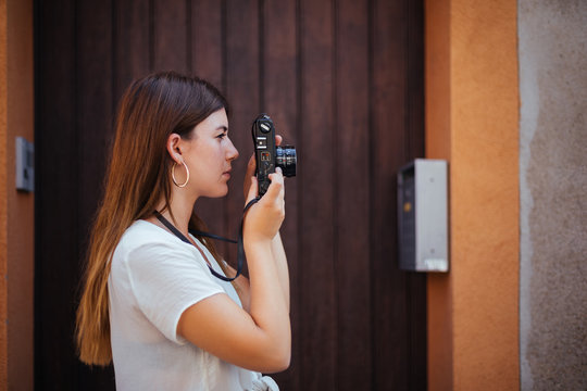 Young girl posing with a vintage camera