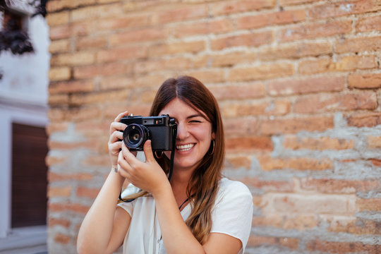 Young girl posing with a vintage camera
