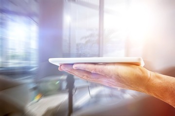 Composite image of mans hand holding digital tablet