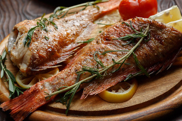 Dinner table with fried fish, close view