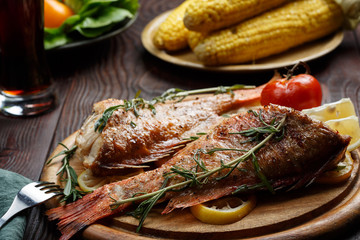 Dinner table with fried fish, close view