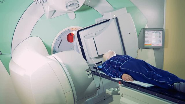 Elements of a linear accelerator are revolving around a patient