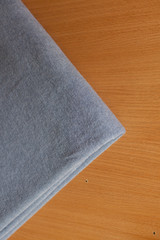 grey Angora fabric. fabric on wooden background. the fabric is mohair on a yellow background