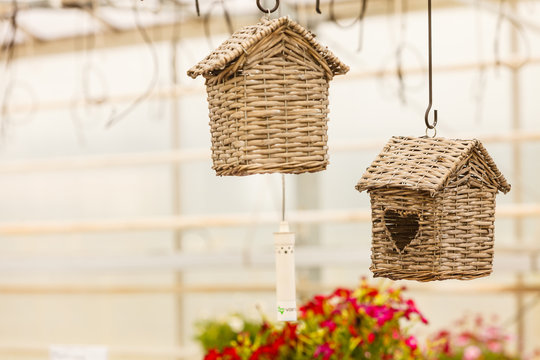 Hanging under ceiling wicker houses for birds