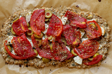 Top view of fresh baked vegetarian pizza on the baking paper