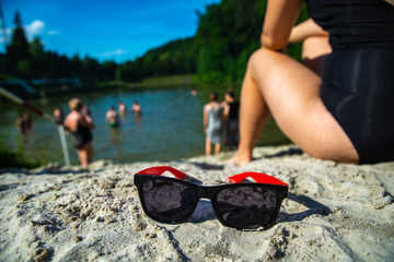 woman sitting at beach with sunglasses close up. summer time