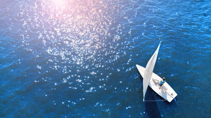 Concept of a navigation to purpose.  Aerial of a little yacht of a catboat type. © Dmytro