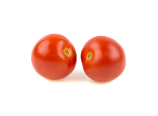 two red ripe tomatoes on a white background