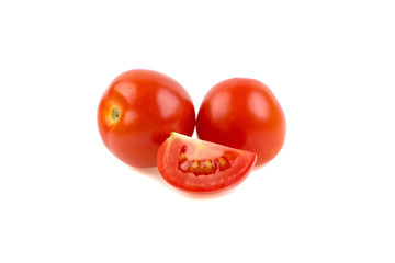 two red ripe tomatoes and a slice on a white background