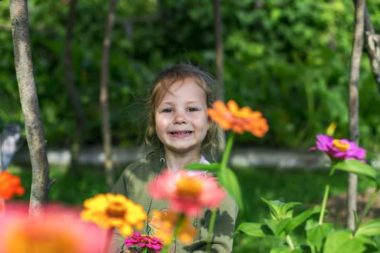 little and happy girl on flowers background
