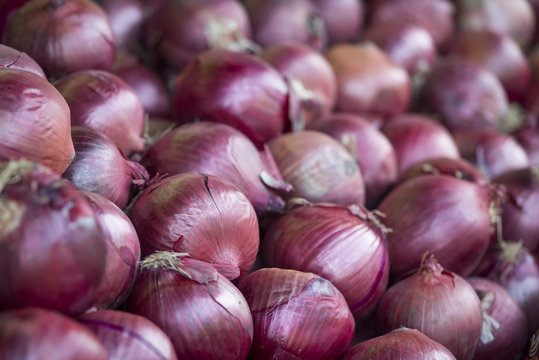 Pile of whole red onions.