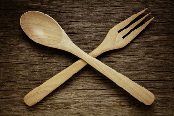 wood spoon and fork on old wooden desk. - vintage style.