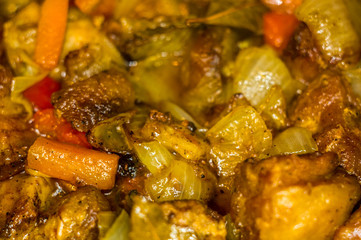 Roast meat, onions, carrots and spices, boiling in oil