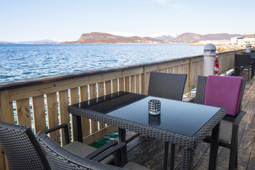 Fototapeta premium Table at the sea in Alesund town, Norway