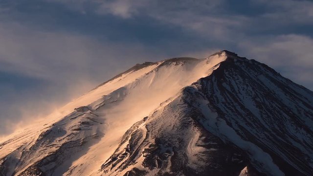Pan Shot : Top of beautiful Fuji mountain with snow cover on the top with could