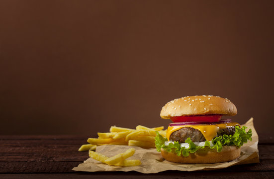 Fresh delicious burger on a wooden background