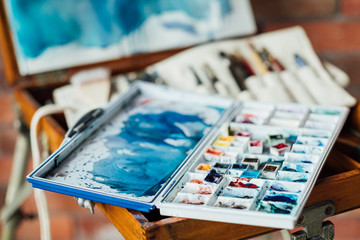 art painting leisure craft and hobby. drawing and creativity concept. messy watercolor palette. artist instruments and tools.