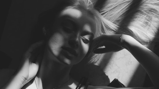 Black and white art fashion surrealistic portrait of beautiful woman with a beamof light and shadow on her face