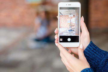 mobile photography. creative hobby and artful leisure. woman hands taking photo of a painter using smart phone.