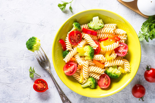 Vegan pasta fusilli with vegetables. Top view.