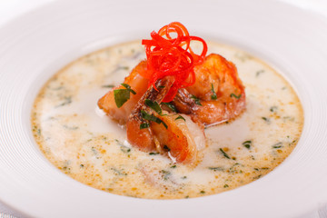 Cream soup with seafood, grilled prawns, mussels. Mediterranean restaurant menu