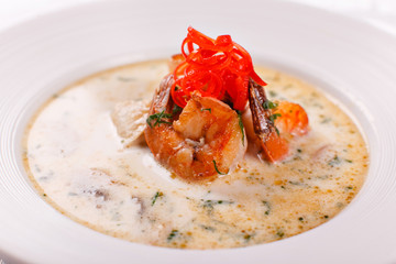 Cream soup with seafood, grilled prawns, mussels. Mediterranean restaurant menu