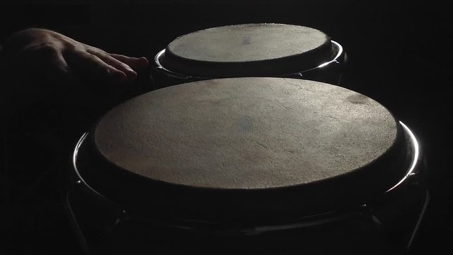 Man is playing on the bongos