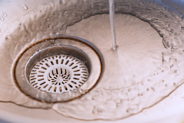 Kitchen sink with water. Background. Water splashes down. Concept.