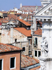 rooftop view of interior, Venice, Italy, with elaborate white building on right with statue