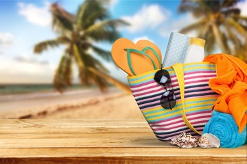 Bag, flip flops on a tropical beach