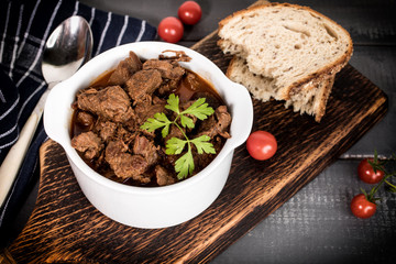 Beef meat stew in ceramic pot.
