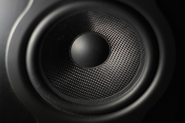 Close up of a cone of a studio speaker (black). Concept: tweeter, subwoofer, audio, recording, music, technology